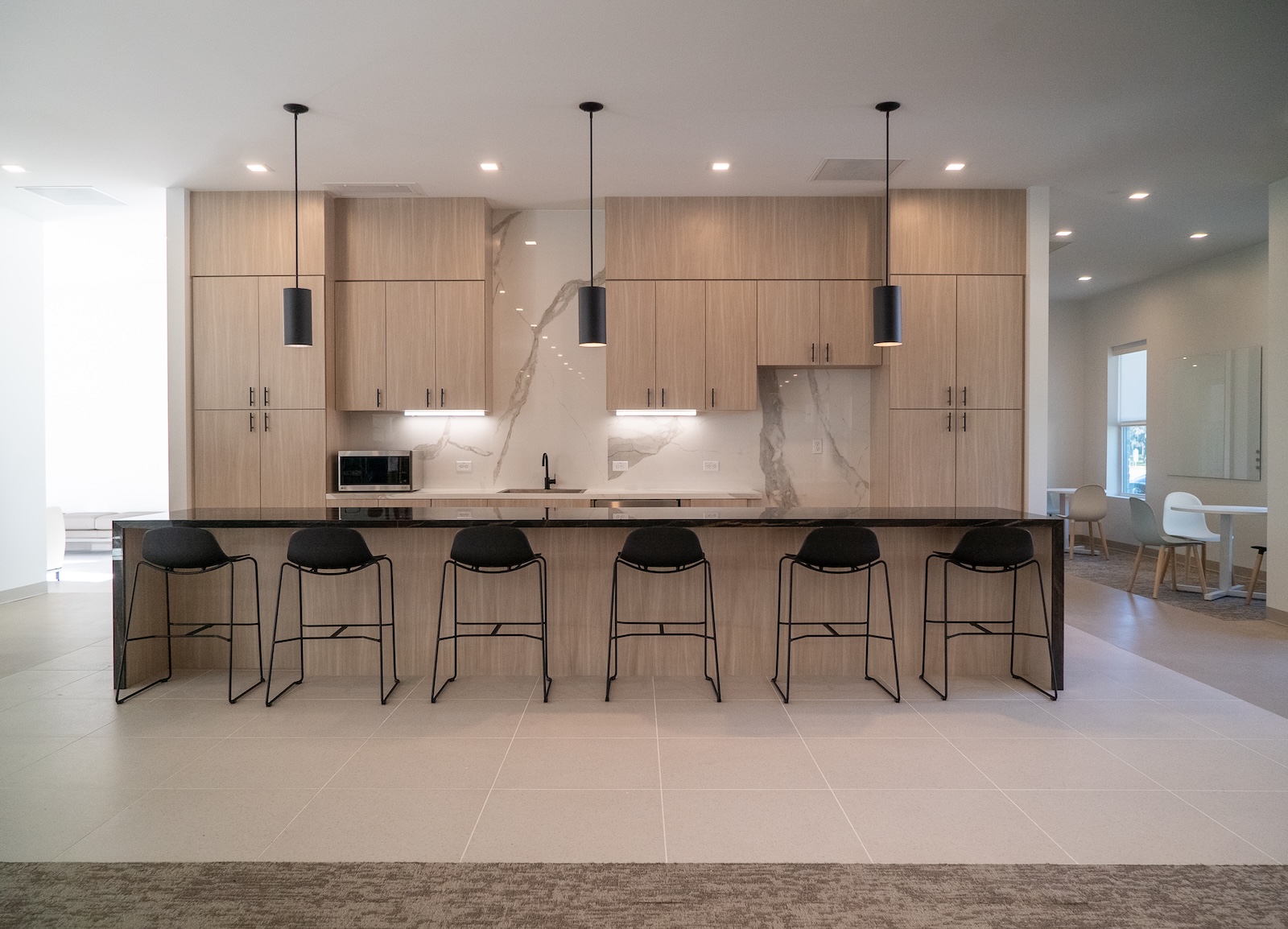Songwon breakroom with CRossville tile on backsplash and porcelain panels on island and counters