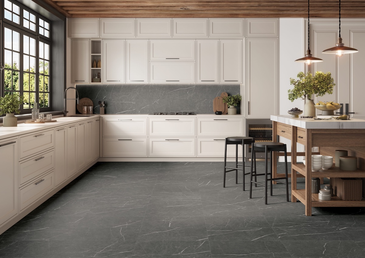 Sociale porcelain floor and wall tile on kitchen floor and back splash in gray.